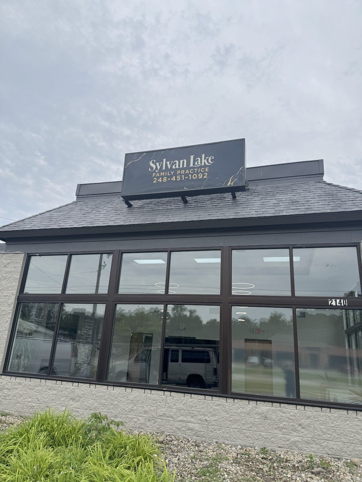 The Sylvan Lake Family Practice building, with its rooftop sign reading Sylvan Lake Family Practice, 248-451-1092